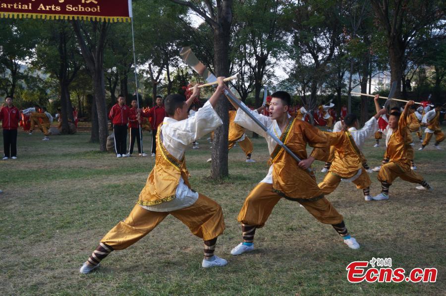 Kung fu students perform during the opening ceremony of the 11th Zhengzhou International Shaolin Kung Fu Festival in Dengfeng, Central China’s Henan Province, Oct. 16, 2016. Students from the famed Tagou Kung Fu School showed off all kinds of kung fu stunts. (Photo: China News Service/Han Zhangyun)