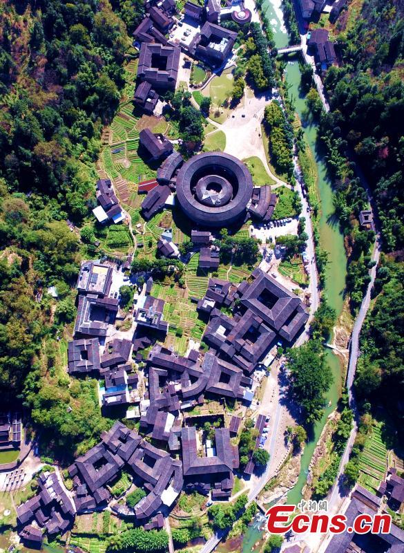 An aerial view of the Tulou in Yongding county, Southeast China\'s Fujian province, on Dec 9, 2016. Yongding has over 23,000 Tulou, a type of Chinese rural dwellings of the Hakka and Minnan people in the mountainous areas in Fujian province. Fujian Tulou is a type of Chinese rural dwellings of the Hakka and Minnan people in the mountainous areas in Fujian province. A total of 46 Fujian Tulou sites have been inscribed in 2008 by UNESCO as World Heritage Site. The biggest Tulou in Fujian is Chengqi Tulou in Yongding, which was listed as a Guinness World Record in 2010. (Photo: China News Service/ Wang Dongming)