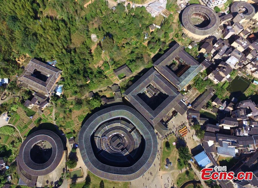 An aerial view of the Tulou in Yongding county, Southeast China\'s Fujian province, on Dec 9, 2016. Yongding has over 23,000 Tulou, a type of Chinese rural dwellings of the Hakka and Minnan people in the mountainous areas in Fujian province. Fujian Tulou is a type of Chinese rural dwellings of the Hakka and Minnan people in the mountainous areas in Fujian province. A total of 46 Fujian Tulou sites have been inscribed in 2008 by UNESCO as World Heritage Site. The biggest Tulou in Fujian is Chengqi Tulou in Yongding, which was listed as a Guinness World Record in 2010. (Photo: China News Service/ Wang Dongming)