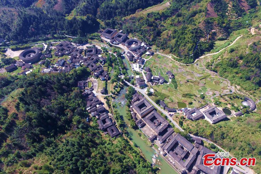 An aerial view of the Tulou in Yongding county, Southeast China\'s Fujian province, on Dec 9, 2016. Yongding has over 23,000 Tulou, a type of Chinese rural dwellings of the Hakka and Minnan people in the mountainous areas in Fujian province. Fujian Tulou is a type of Chinese rural dwellings of the Hakka and Minnan people in the mountainous areas in Fujian province. A total of 46 Fujian Tulou sites have been inscribed in 2008 by UNESCO as World Heritage Site. The biggest Tulou in Fujian is Chengqi Tulou in Yongding, which was listed as a Guinness World Record in 2010. (Photo: China News Service/ Wang Dongming)