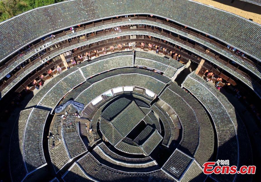 
An aerial view of the Tulou in Yongding county, Southeast China\'s Fujian province, on Dec 9, 2016. Yongding has over 23,000 Tulou, a type of Chinese rural dwellings of the Hakka and Minnan people in the mountainous areas in Fujian province. Fujian Tulou is a type of Chinese rural dwellings of the Hakka and Minnan people in the mountainous areas in Fujian province. A total of 46 Fujian Tulou sites have been inscribed in 2008 by UNESCO as World Heritage Site. The biggest Tulou in Fujian is Chengqi Tulou in Yongding, which was listed as a Guinness World Record in 2010. (Photo: China News Service/ Wang Dongming)