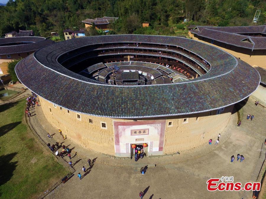 An aerial view of the Tulou in Yongding county, Southeast China\'s Fujian province, on Dec 9, 2016. Yongding has over 23,000 Tulou, a type of Chinese rural dwellings of the Hakka and Minnan people in the mountainous areas in Fujian province. Fujian Tulou is a type of Chinese rural dwellings of the Hakka and Minnan people in the mountainous areas in Fujian province. A total of 46 Fujian Tulou sites have been inscribed in 2008 by UNESCO as World Heritage Site. The biggest Tulou in Fujian is Chengqi Tulou in Yongding, which was listed as a Guinness World Record in 2010. (Photo: China News Service/ Wang Dongming)