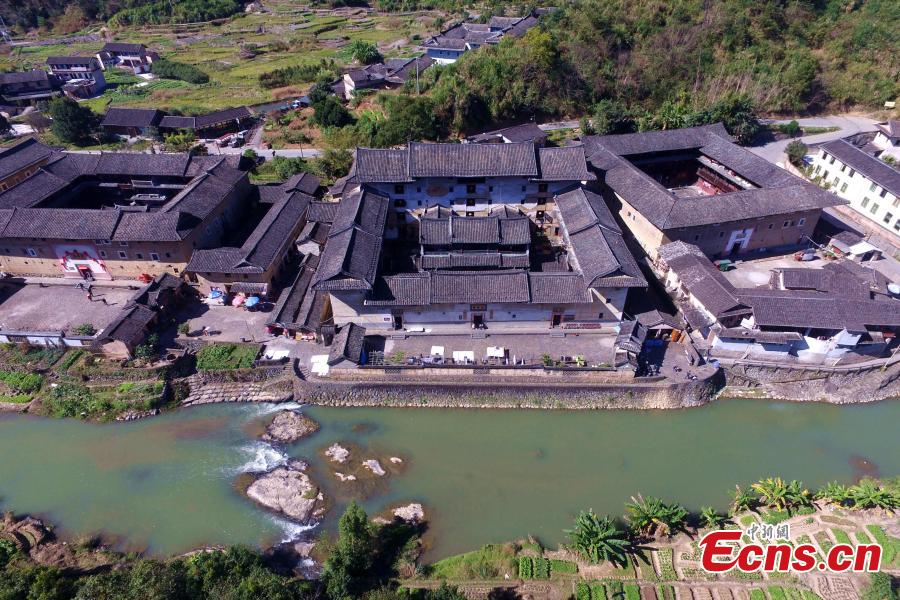 An aerial view of the Tulou in Yongding county, Southeast China\'s Fujian province, on Dec 9, 2016. Yongding has over 23,000 Tulou, a type of Chinese rural dwellings of the Hakka and Minnan people in the mountainous areas in Fujian province. Fujian Tulou is a type of Chinese rural dwellings of the Hakka and Minnan people in the mountainous areas in Fujian province. A total of 46 Fujian Tulou sites have been inscribed in 2008 by UNESCO as World Heritage Site. The biggest Tulou in Fujian is Chengqi Tulou in Yongding, which was listed as a Guinness World Record in 2010. (Photo: China News Service/ Wang Dongming)