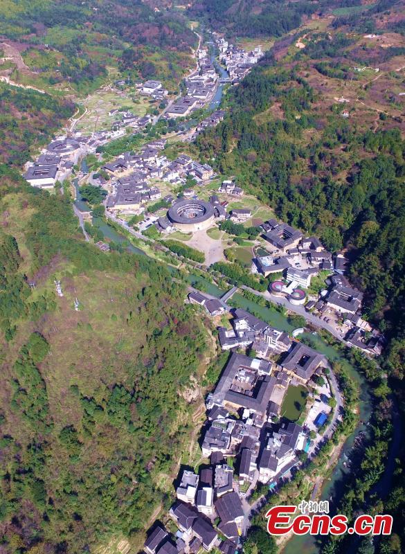 An aerial view of the Tulou in Yongding county, Southeast China\'s Fujian province, on Dec 9, 2016. Yongding has over 23,000 Tulou, a type of Chinese rural dwellings of the Hakka and Minnan people in the mountainous areas in Fujian province. Fujian Tulou is a type of Chinese rural dwellings of the Hakka and Minnan people in the mountainous areas in Fujian province. A total of 46 Fujian Tulou sites have been inscribed in 2008 by UNESCO as World Heritage Site. The biggest Tulou in Fujian is Chengqi Tulou in Yongding, which was listed as a Guinness World Record in 2010. (Photo: China News Service/ Wang Dongming)