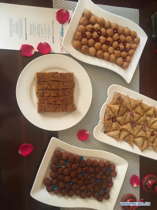 Traditional cuisines in Maldives are introduced by Ambassador of the Maldives to China Mohamed Faisal and his wife during the activity \