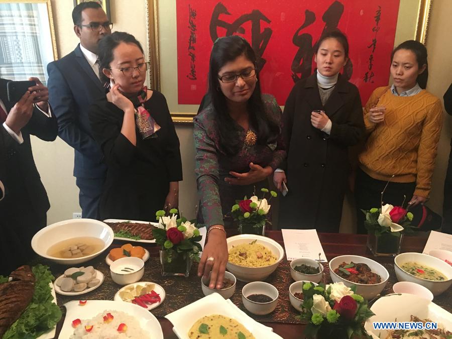 Traditional cuisines in Maldives are introduced by Ambassador of the Maldives to China Mohamed Faisal(L2) and his wife(R3) during the activity \