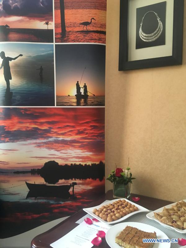 Traditional cuisines in Maldives are introduced by Ambassador of the Maldives to China Mohamed Faisal and his wife during the activity \