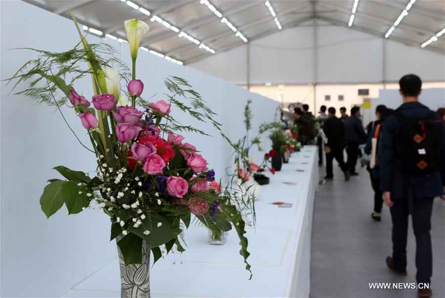 Reporters view flower exhibits during the preview of the Hong Kong Flower Show at Victoria Park in Hong Kong, south China, March 9, 2017. The flower show will be held from 10 to 19 this March. (Xinhua/Li Peng)