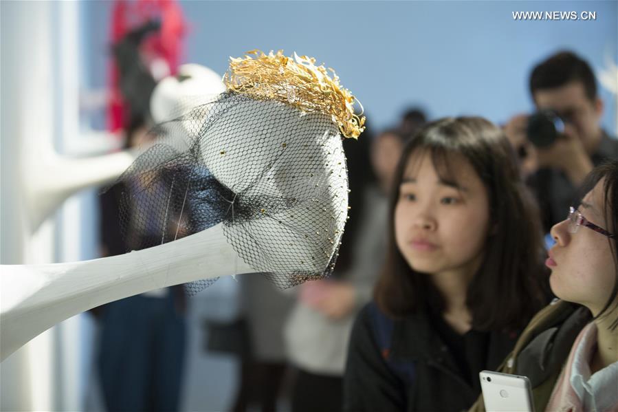 Visitors view headwears at the gallery of Nanjing University of the Arts in Nanjing, capital of east China\'s Jiangsu Province, April 8, 2017. (Xinhua/Wang Xin)