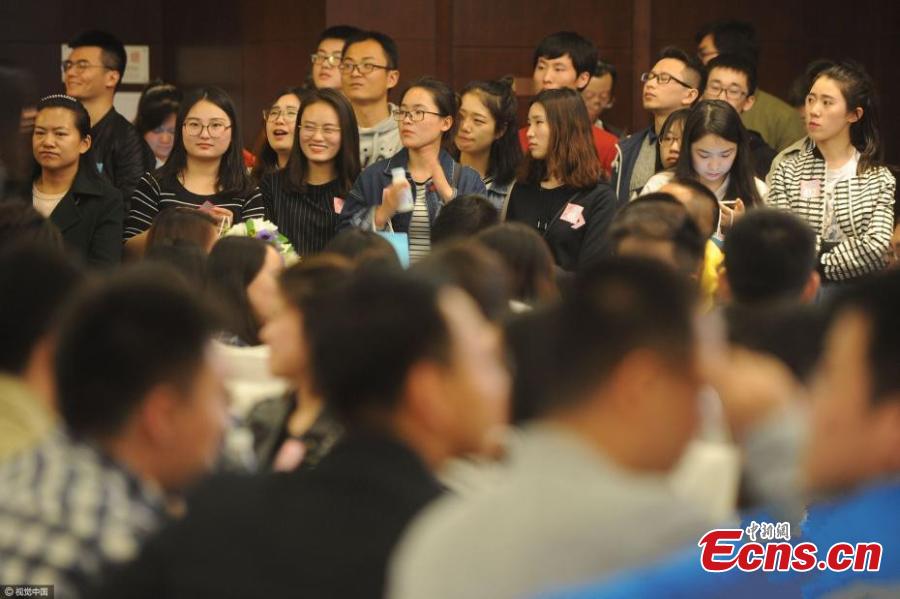 Singles attend a blind date at a hotel in Haidian District, Beijing, April 9, 2017. More than 1,000 single men and women who are studying at top schools such as Peking, Tsinghua and Renmin universities participated the event that lasted for four hours and included five-minute speed dates and games. Some students said they joined the activity because they feel bored alone and regard being in a relationship as a kind of skill. Some participants met about 500 people through the event. The organizer said participants were born in 1999 or earlier. (Photo/CFP)