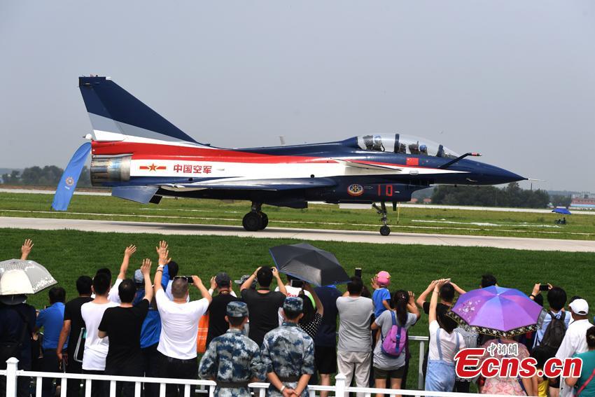 A pilot of the Bayi (August 1) Aerobatics Team waves to spectators after finishing a performance at an air show in Changchun City, the capital of Northeast China’s Jilin Province, Aug. 10, 2017. The show is also part of the International Army Games, which run from July 29 to Aug. 12 and consist of 28 competitions to be held in Russia, China, Azerbaijan, Belarus and Kazakhstan. (Photo: China News Service/Zhang Yao)