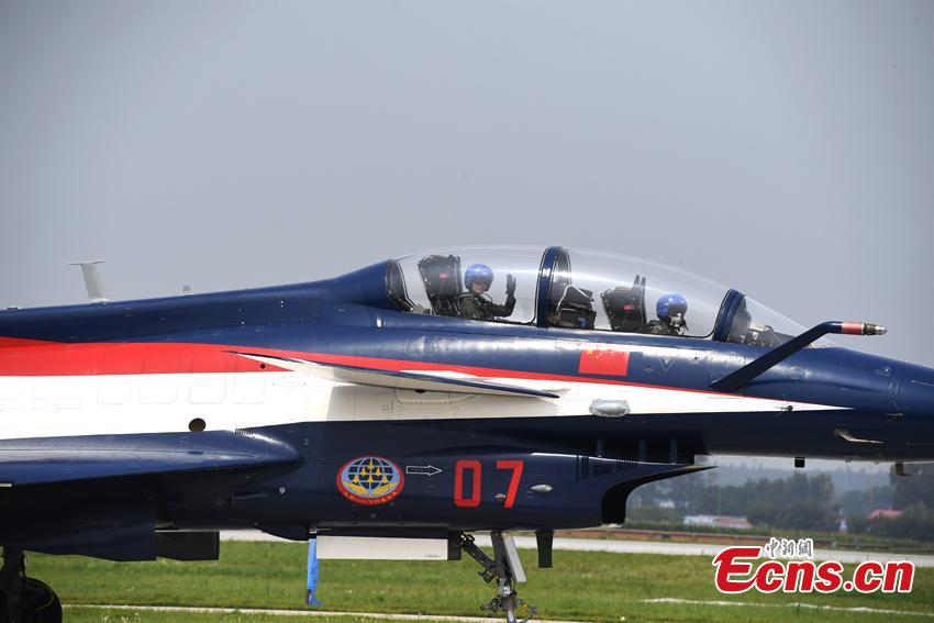 A pilot of the Bayi (August 1) Aerobatics Team waves to spectators after finishing a performance at an air show in Changchun City, the capital of Northeast China’s Jilin Province, Aug. 10, 2017. The show is also part of the International Army Games, which run from July 29 to Aug. 12 and consist of 28 competitions to be held in Russia, China, Azerbaijan, Belarus and Kazakhstan. (Photo: China News Service/Zhang Yao)