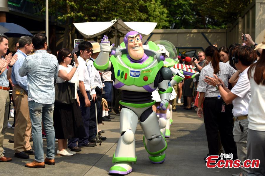 Disneyland character Buzz Lightyear waves to fans attending a farewell ceremony of the Buzz Lightyear Astro Blaster at the Hong Kong Disneyland, Aug. 31, 2017. Buzz Lightyear Astro Blasters, located in Tomorrowland, will be transformed into a new Marvel-themed interactive shooting game, making it the second Marvel-themed attraction following the popular Iron Man Experience. (Photo: China News Service/Tan Daming)