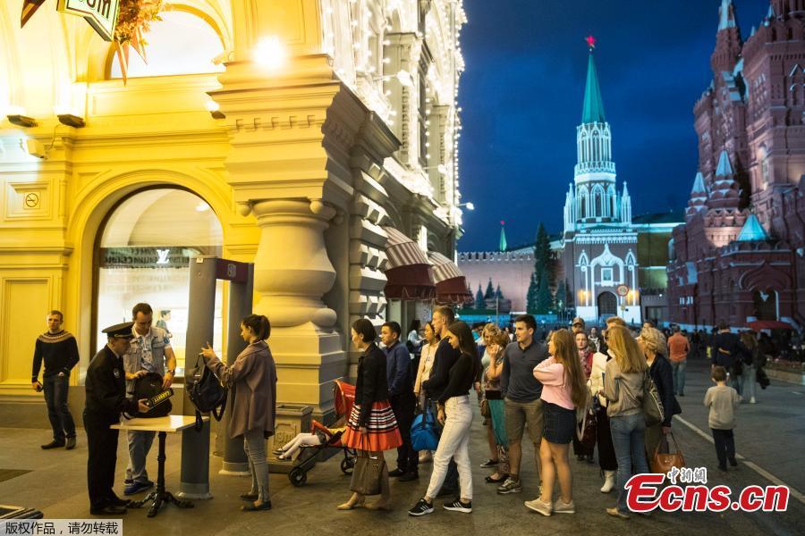 Visitors wait in front of the entrance of the GUM department store near Red Square in Moscow, Russia, Sept. 13, 2017. More than 20,000 people have been evacuated from public spaces across Moscow after authorities received several bomb threats. (Photo/Agencies)