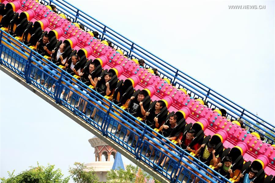 Tourists enjoy themselves at a theme park in Liuzhou, south China\'s Guangxi Zhuang Autonomous Region, Oct. 4, 2017. China witnessed more than 710 million tourist trips during the eight-day National Day and Mid-Autumn holidays, ringing up to about 590 billion yuan (88.68 billion U.S. dollars) in tourism income, according to the National Tourism Administration. (Xinhua/Wang Zichuang)