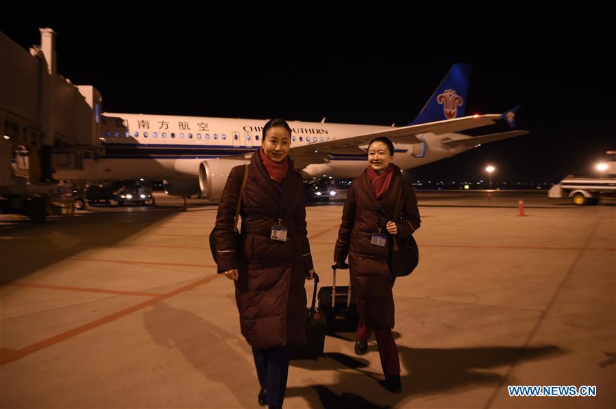 Zhu Aijun (L) and her daughter Li Xinyun prepare to board and work in Shenyang, capital of northeast China's Liaoning Province, Nov. 17, 2017. Zhu Aijun has been a flight attendant in China Southern Airlines since 1987, and Friday is her last flight before retirement. Her daughter Li Xinyun, who became a flight attendant in 2016, has been permitted to fly with her mother. (Xinhua/Long Lei)