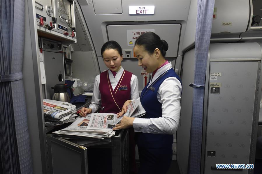 Zhu Aijun (R) and her daughter Li Xinyun prepare to hand out newspapers for passengers in the cabin in Shenyang, capital of northeast China's Liaoning Province, Nov. 17, 2017. Zhu Aijun has been a flight attendant in China Southern Airlines since 1987, and Friday is her last flight before retirement. Her daughter Li Xinyun, who became a flight attendant in 2016, has been permitted to fly with her mother. (Xinhua/Long Lei)