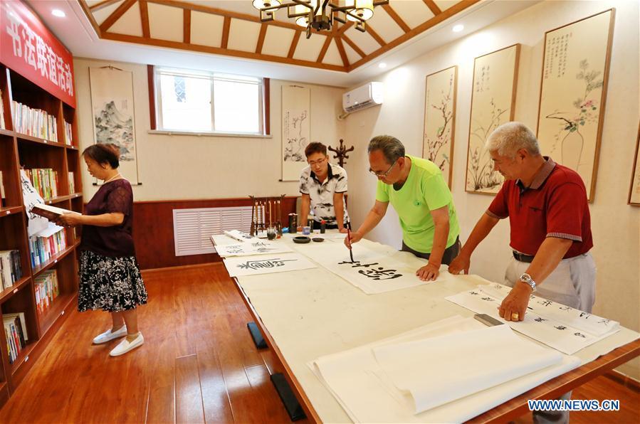 Elderly residents write calligraphy at a daycare center of Yuxin Community in Taocheng District, Hengshui City, north China's Hebei Province, Aug. 3, 2017. Eight daycare centers for the elderly have been established to provide older people with food, entertainment, counselling and physical health care since 2016 in Taocheng District. (Xinhua/Mu Yu)