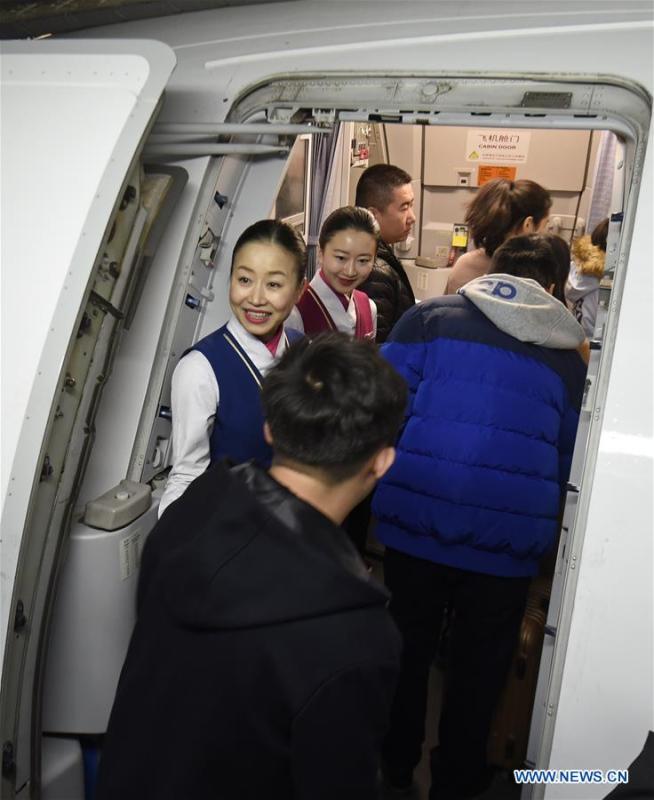 Zhu Aijun (front) and her daughter Li Xinyun greet passengers in the cabin in Shenyang, capital of northeast China's Liaoning Province, Nov. 17, 2017. Zhu Aijun has been a flight attendant in China Southern Airlines since 1987, and Friday is her last flight before retirement. Her daughter Li Xinyun, became a flight attendant in 2016, who has been permitted to fly with her mother. (Xinhua/Long Lei)