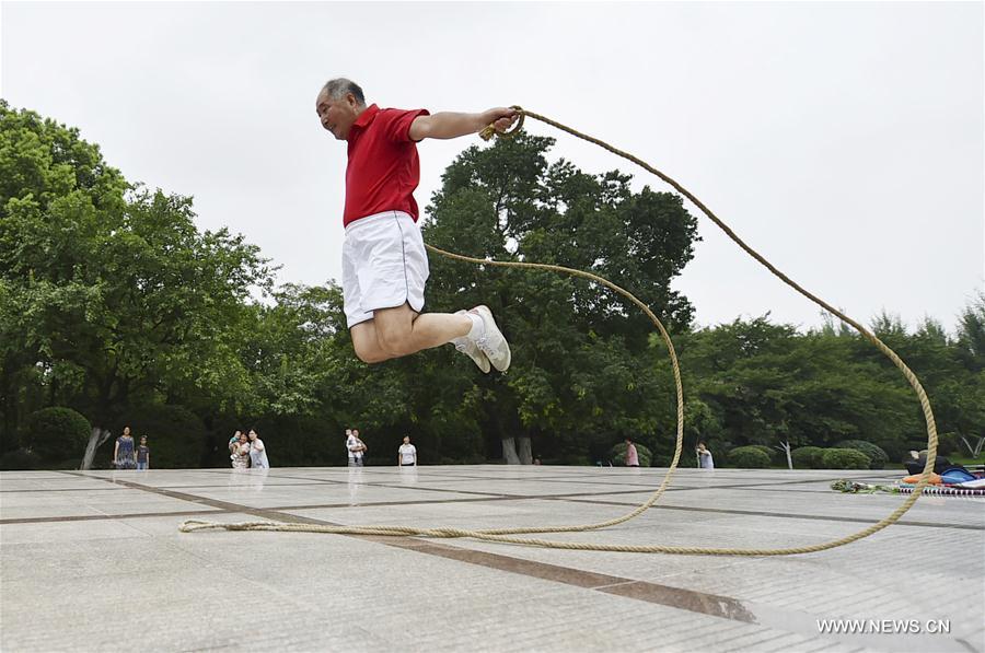 Gao Bi, 68-year-old retired PE teacher, practices rope skipping at a park in Hefei, capital of east China's Anhui Province, Aug. 16, 2017. As a rope skipping enthusiast, Gao Bi has created over 100 kinds of rope skipping techniques. (Xinhua/Yang Xiaoyuan)