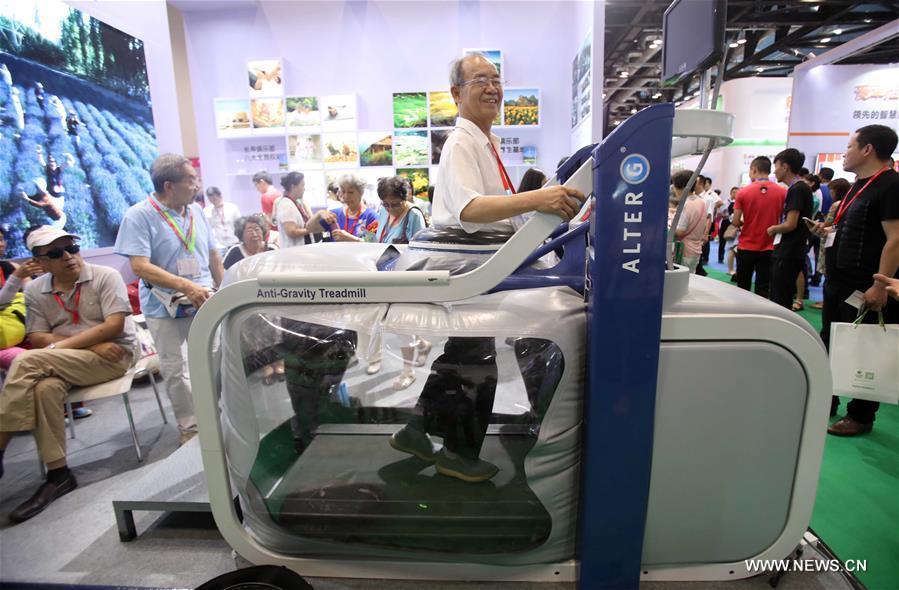 An elderly uses an anti-gravity treadmill during the 6th China International Senior Services Expo in Beijing, capital of China, Aug. 4, 2017. The 6th China International Senior Services Expo (CISSE) kicked off in Beijing National Convention Center on Friday. More than 200 social organizations, institutions and enterprises from over 20 countries and regions attended the exhibition. (Xinhua/Chen Xiaogen)