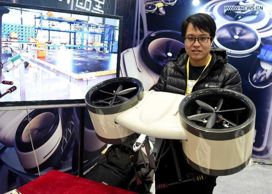 An exhibitor shows arobot that does operation work in the air at 2017 International Innovation & Entrepreneurship Expo in Beijing, capital of China, Dec. 9, 2017. The three-day expo kicked off at Beijing International Convention Center on Friday. (Xinhua/LuoXiaoguang)