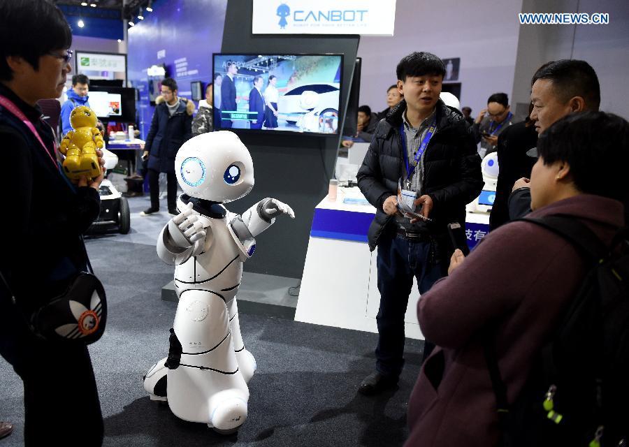 A robot plays finger-guessing game with human at 2017 International Innovation & Entrepreneurship Expo in Beijing, capital of China, Dec. 9,2017. The three-day expo kicked off at Beijing International Convention Center on Friday. (Xinhua/Luo Xiaoguang)