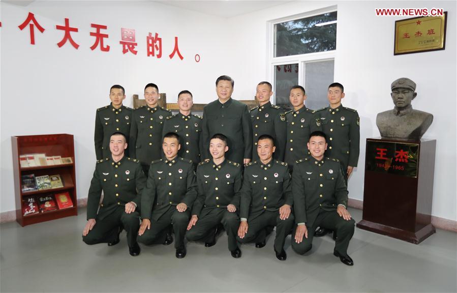 Chinese President Xi Jinping (C, rear), also general secretary of the Communist Party of China (CPC) Central Committee and chairman of the Central Military Commission, poses for photos with soldiers of a squad named after the hero soldier Wang Jie, in Xuzhou, east China\'s Jiangsu Province, Dec. 13, 2017. Xi inspected the 71st Group Army of the People\'s Liberation Army in Xuzhou on Dec. 13. (Xinhua/Li Gang)