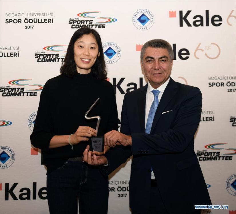 Zhu Ting (L) receives the award from Turkish Volleyball Federation official Kurtaran Mumcu during the awarding ceremony at Bosphorus University in Istanbul, Turkey, Dec. 18, 2017. Chinese volleyball star and Turkey\'s Vakifbank player Zhu Ting was awarded the Best Volleyball Player of 2017 Bosphorus University Sports Awards here on Monday. (Xinhua/He Canling)