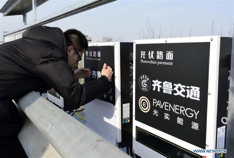 Power-generating equipments of a solar expressway are seen in Jinan, capital of east China\'s Shandong Province, Dec. 22, 2017. China on Thursday opened a 1-km section solar expressway for testing. Solar panels are laid beneath part of a ring road surrounding Jinan. The road surface is made of a transparent, weight-bearing material that allows sunlight to penetrate. The panels, covering 5,875 square meters, can generate 1 million kwh of power in a year, enough to meet the everyday demand of around 800 households.(Xinhua/Zhu Zheng)