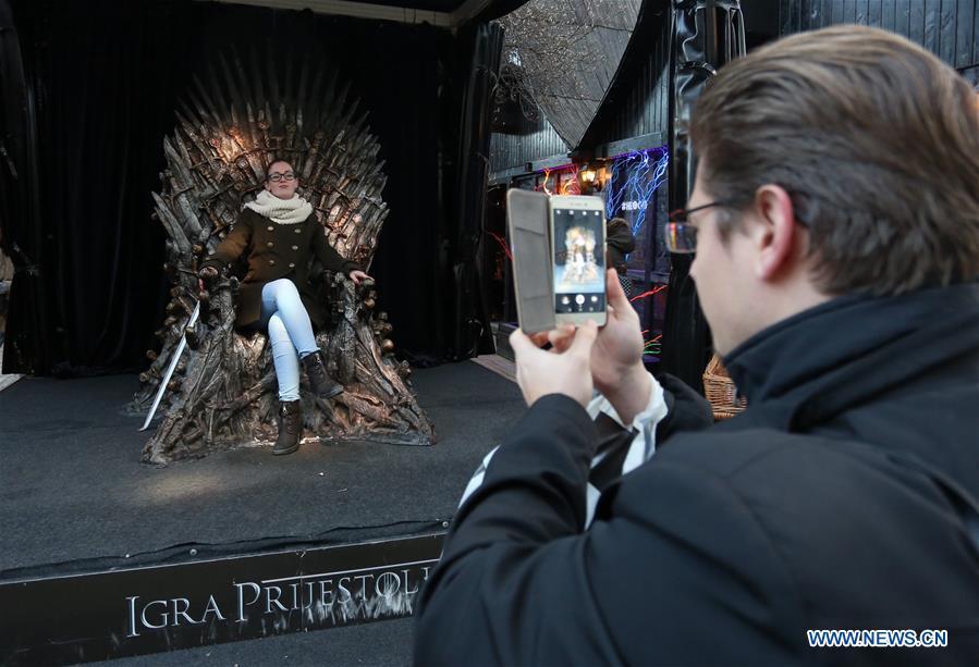 Visitor poses on 'iron chair' used in Game of Thrones (1/1)