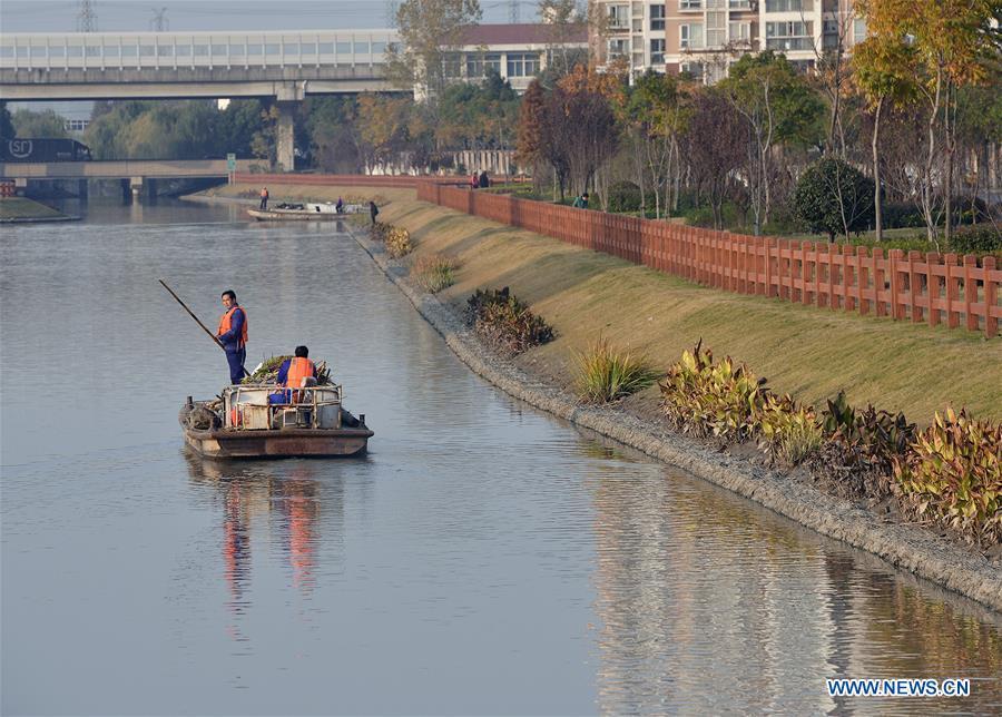 
Sanitation staff work in Yingtao River of Wujing Town in Minhang District of Shanghai, a city of Taihu Lake basin in east China, Dec. 6, 2017. China has made strides in rolling out a \