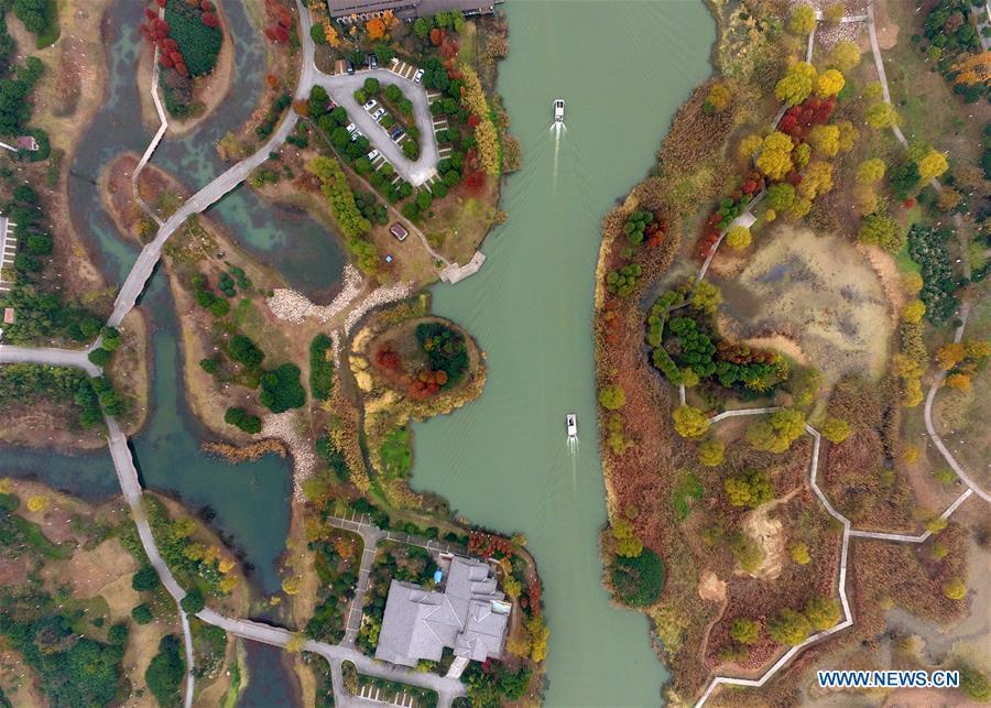 Two tourist boats sail in the Changguangxi River scenic zone in Wuxi, a city of Taihu Lake basin in east China\'s Jiangsu Province, Dec. 7, 2017. China has made strides in rolling out a \