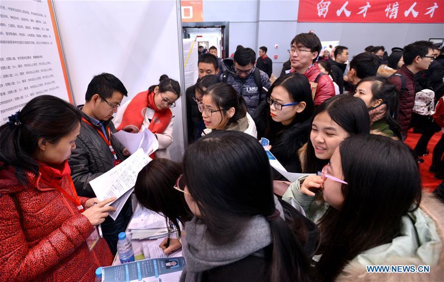 Graduates consult employment information at a job fair in Xidian University in Xi\'an, capital of northwest China\'s Shaanxi Province, Jan. 10, 2018. About 8,000 job opportunities were offered to the college graduates at the job fair on Wednesday. Xi\'an will hold more job fairs across the nation until May next year to attract one million college graduates to work in Xi\'an. (Xinhua/Liu Xiao)