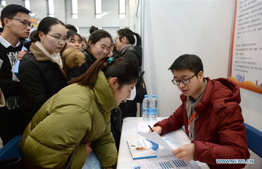 A graduate (L, front) consults employment information at a job fair in Xidian University in Xi\'an, capital of northwest China\'s Shaanxi Province, Jan. 10, 2018. About 8,000 job opportunities were offered to the college graduates at the job fair on Wednesday. Xi\'an will hold more job fairs across the nation until May next year to attract one million college graduates to work in Xi\'an. (Xinhua/Liu Xiao)