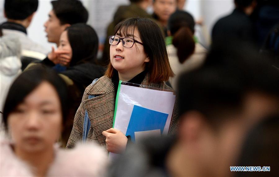 A graduate attends a job fair in Xidian University in Xi\'an, capital of northwest China\'s Shaanxi Province, Jan. 10, 2018. About 8,000 job opportunities were offered to the college graduates at the job fair on Wednesday. Xi\'an will hold more job fairs across the nation until May next year to attract one million college graduates to work in Xi\'an. (Xinhua/Liu Xiao)