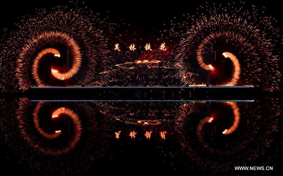 
Sparks pour down as performers spray burning iron chips to shower sparks-like fireworks in Cixian County, north China\'s Hebei Province, Feb. 17, 2018. The performance was held to celebrate the Spring Festival, or the Chinese Lunar New Year, which fell on Feb. 16 this year. (Xinhua/Wang Xiao)