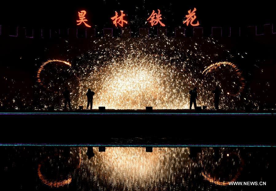 Sparks pour down as performers spray burning iron chips to shower sparks-like fireworks in Cixian County, north China\'s Hebei Province, Feb. 17, 2018. The performance was held to celebrate the Spring Festival, or the Chinese Lunar New Year, which fell on Feb. 16 this year. (Xinhua/Wang Xiao)