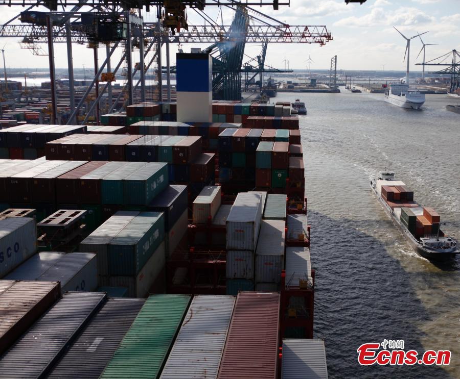 China\'s colossal container vessel COSCO Shipping Aries docks at the Port of Antwerp in Belgium during its maiden voyage, Feb. 27, 2018. The 20,000 TEU vessel is the first ultra-large containership built and operated by a Chinese company. COSCO Shipping Aries is 400 meters long, 58.6 meters wide and 30.7 meters high, with a maximum load capacity of 197,000 tons. Its deck area is larger than four standard soccer stadiums. (Photo: China News Service/De Yongjian)
