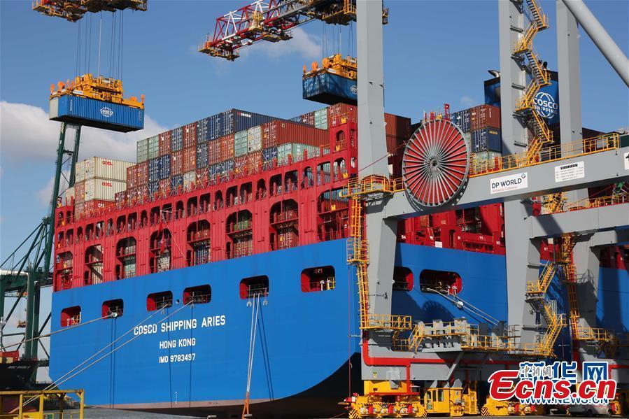 China\'s colossal container vessel COSCO Shipping Aries docks at the Port of Antwerp in Belgium during its maiden voyage, Feb. 27, 2018. The 20,000 TEU vessel is the first ultra-large containership built and operated by a Chinese company. COSCO Shipping Aries is 400 meters long, 58.6 meters wide and 30.7 meters high, with a maximum load capacity of 197,000 tons. Its deck area is larger than four standard soccer stadiums. (Photo/Xinhua)