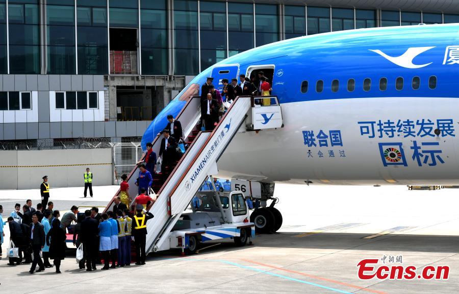 A Xiamen Airlines plane, featuring the UN Sustainable Development Goals (SDGs) in its exterior decoration, arrives in Fuzhou City, the capital of East China\'s Fujian Province, March 21, 2018. In an effort to create more awareness about the goals, the airline painted the exterior of one of its aircraft with the theme, a first for the airlines industry. The two sides signed the agreement at the UN headquarters in New York to underscore the airlines\' commitment to supporting the new development agenda on Feb. 15, 2017. (Photo: China News Service/Wang Dongming)
