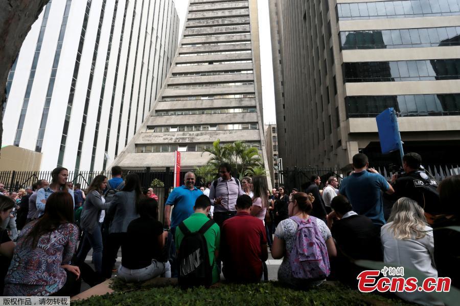 People gather in front of an evacuated building, after an earthquake that hit Bolivia, at Paulista avenue in Sao Paulo, Brazil, April 2, 2018. The tremor was also felt in Brasilia and Sao Paulo. An earthquake of at least 6.6 magnitude shook Bolivia early on Monday, causing no damage or injuries but driving people out of office buildings as far away as Brasilia and Sao Paulo in neighboring Brazil, officials said. (Photo/Agencies)