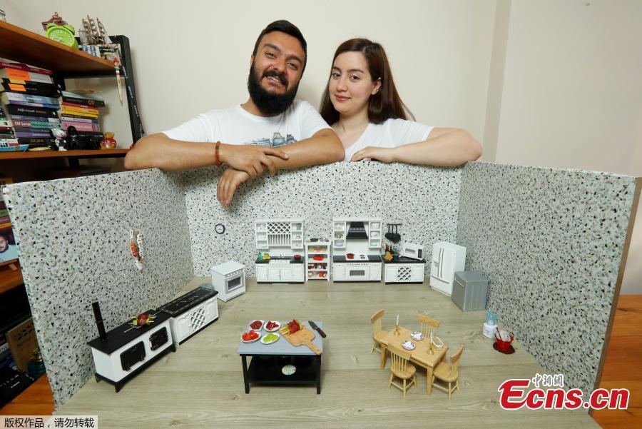 Videographer Anil Aydin and his wife, miniature food cook Burcu Celenoglu Aydin, pose with their mini kitchen in Istanbul, Turkey, April 7, 2018. Burcu Celenoglu Aydin and her husband Anil Aydin cook the dishes in a miniature kitchen with a tiny stove and utensils and upload the videos to their YouTube channel \'Mini Turk Mutfagi,\' which means Mini Turkish Kitchen. (Photo/Agencies)