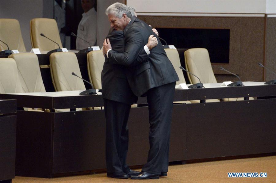 Raul Castro (L), hugs with Miguel Diaz-Canel during the closing ceremony of a session of Cuba\'s National Assembly of People\'s Power, in Havana, capital of Cuba, on April 19, 2018. Miguel Diaz-Canel was elected on Thursday as Cuba\'s new president, as the successor of Raul Castro who concluded two consecutive five-year terms in office. (Xinhua/Joaquin Hernandez)