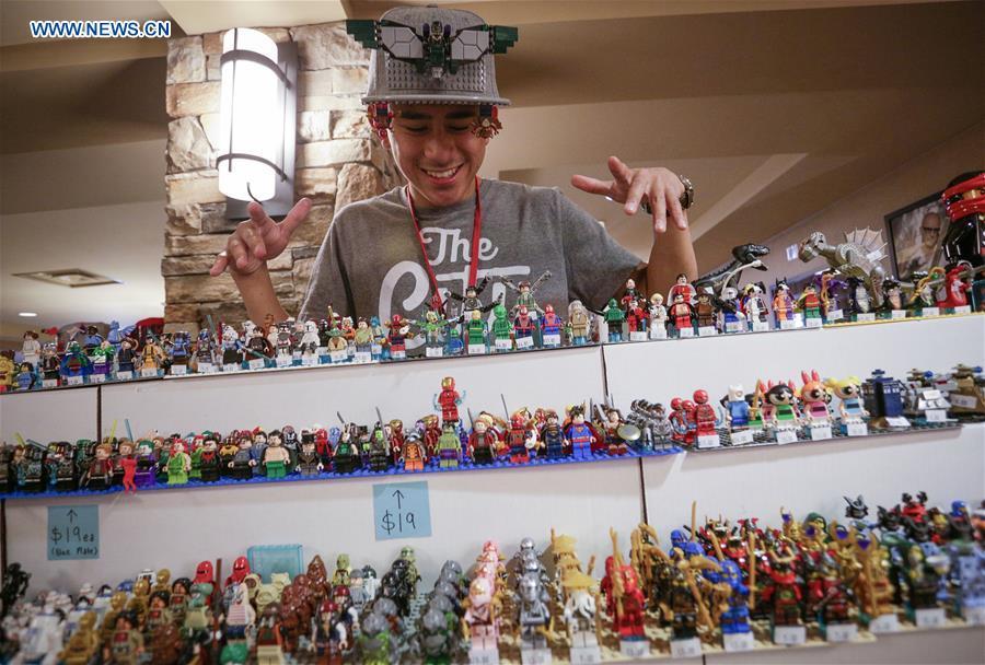 
A vendor displays his LEGO mini figures at the BrickCan LEGO convention in Vancouver, Canada, April 21, 2018. About 200 LEGO builders across the world showcased more than 6,000 pieces of creations at the annual BrickCan event which is claimed to be Canada\'s largest public LEGO fan convention. (Xinhua/Liang Sen)
