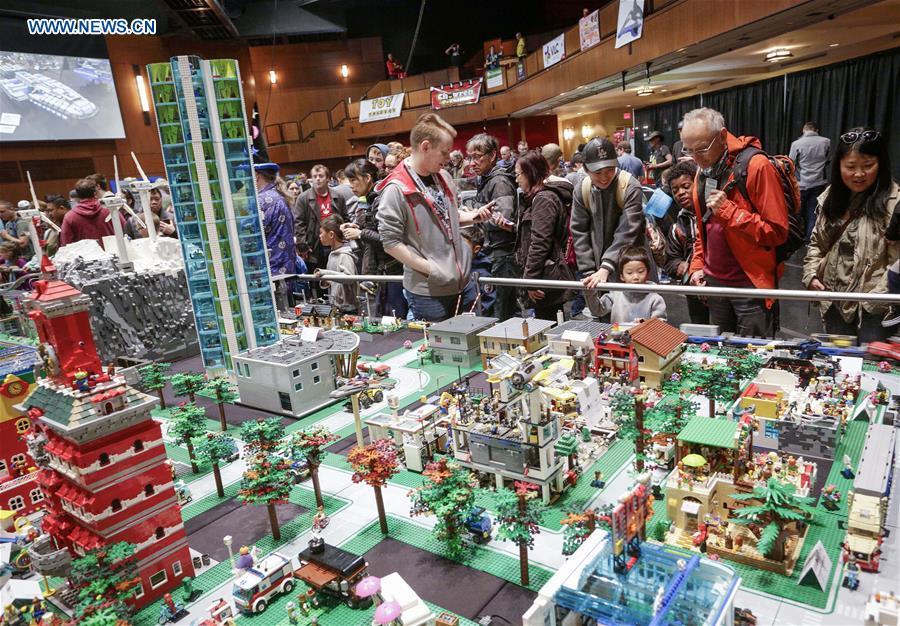People view LEGO miniature town at the BrickCan LEGO convention in Vancouver, Canada, April 21, 2018. About 200 LEGO builders across the world showcased more than 6,000 pieces of creations at the annual BrickCan event which is claimed to be Canada\'s largest public LEGO fan convention. (Xinhua/Liang Sen)