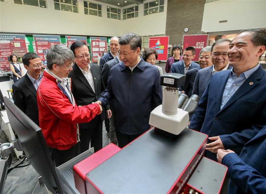Chinese President Xi Jinping, also general secretary of the Communist Party of China Central Committee and chairman of the Central Military Commission, shakes hands with a scientific research personnel at Peking University (PKU) in Beijing, capital of China, May 2, 2018. Xi made an inspection tour of PKU on Wednesday. (Xinhua/Yao Dawei)