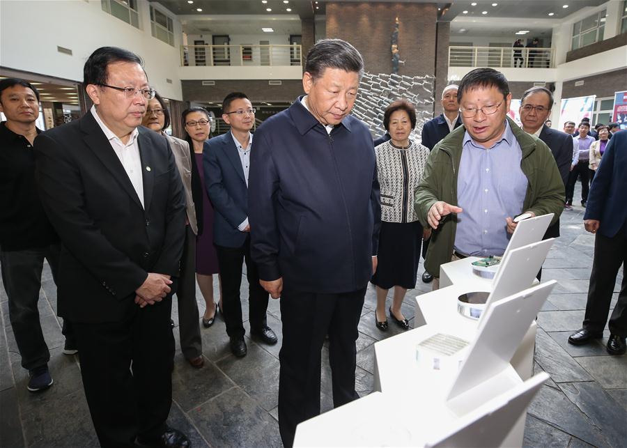 Chinese President Xi Jinping, also general secretary of the Communist Party of China Central Committee and chairman of the Central Military Commission, watches scientific research devices and physical models at Peking University (PKU) in Beijing, capital of China, May 2, 2018. Xi made an inspection tour of PKU on Wednesday. (Xinhua/Yao Dawei)