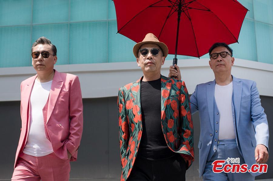 Three men, all in their sixties, pose during a fashion shoot in Nanjing, East China\'s Jiangsu Province. Chen Shuai, who has worked in elderly care for many years, organized the event - persuading the three men, who were 68, 66, and 61 years old respectively, to don fashionable outfits and pose for photos they themselves found surprising. (Photo provided to China News Service)