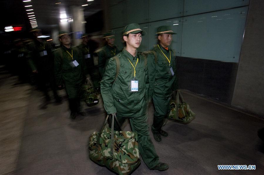 File photo taken on Dec. 12, 2008 shows Jiang Yuhang, as a new recruit, arriving at the Shanghai Railway Station in Shanghai, east China. On May 17, 2008, Jiang, a 20-year-old highway administration employee, was extricated by firefighters, 123 hours after he was trapped in the rubble at quake-hit Yingxiu Township of Wenchuan County, southwest China\'s Sichuan Province. Jiang was a survivor of the 8.0-magnitude earthquake that struck Sichuan\'s Wenchuan County on May 12, 2008. The quake left more than 69,000 dead, 374,000 injured, 18,000 missing and millions homeless. Jiang said it were firefighters who gave him the second life, and he desired to be a soldier like them. At the end of 2008, Jiang realized his dream to join the army and served in the group who once saved him. After training for half a year, he finally became a real fire soldier in Shanghai in 2009. Jiang later got promoted to the position of an officer, and in March this year, he was transferred to the firefighting force in his hometown Kaili City, southwest China\'s Guizhou Province. In the past ten years, the young man, who was saved in that catastrophic earthquake, saved more people\'s lives with his own efforts. (Xinhua/Zhao Yun)